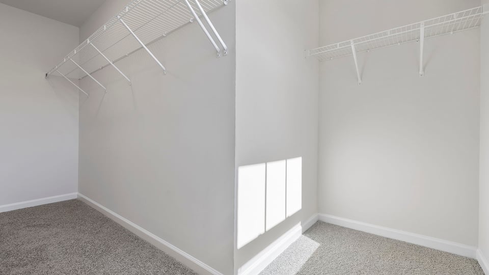 Primary bedroom walk-in closet.
