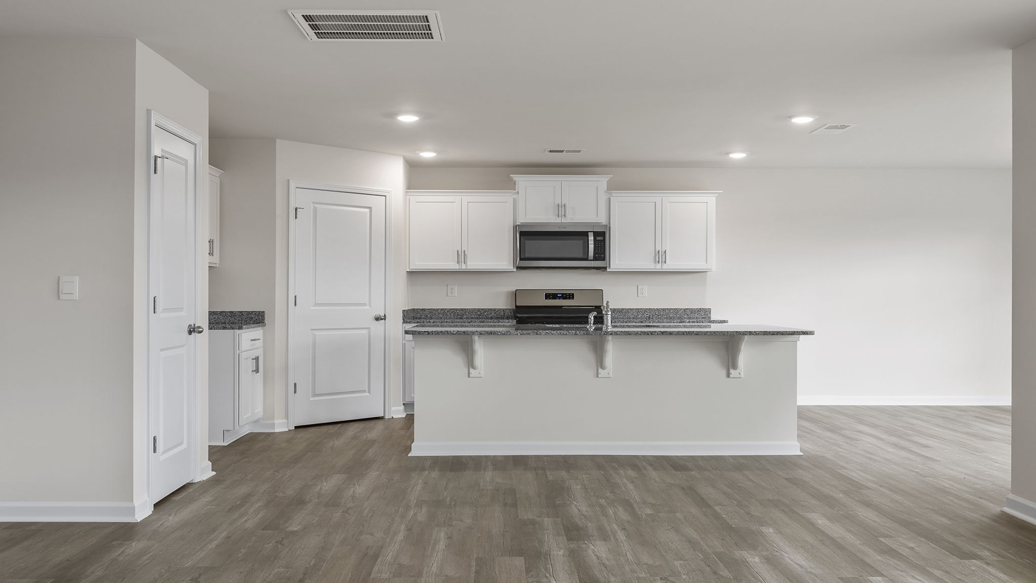 Open kitchen with island with quartz countertops.