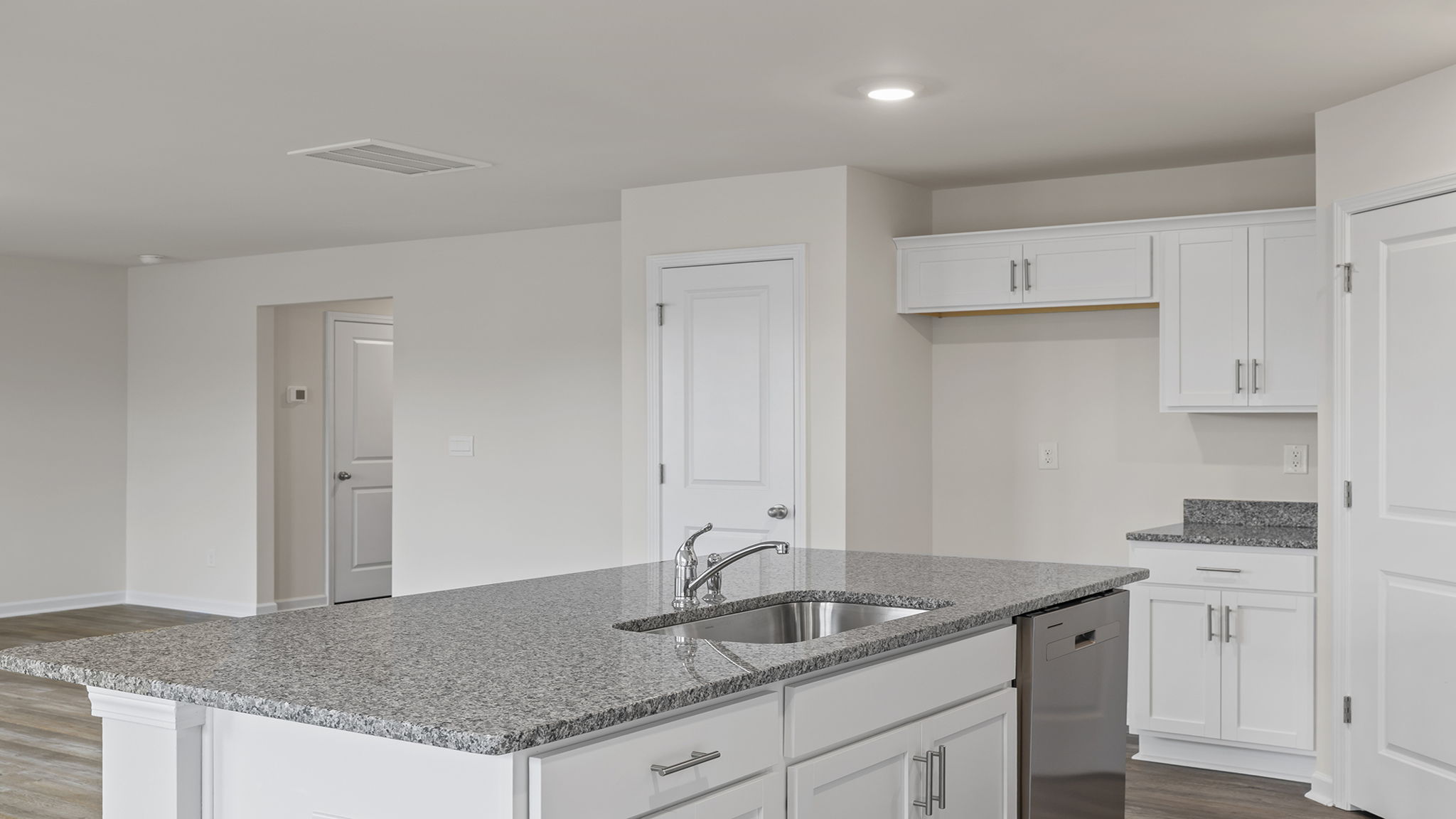 Island has sink and dishwasher near by.