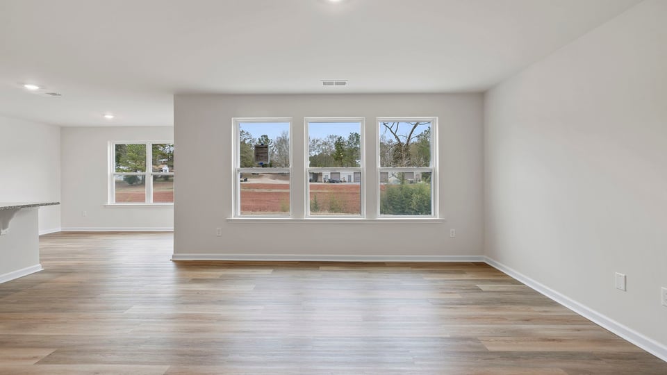 View of family room with three large windows.