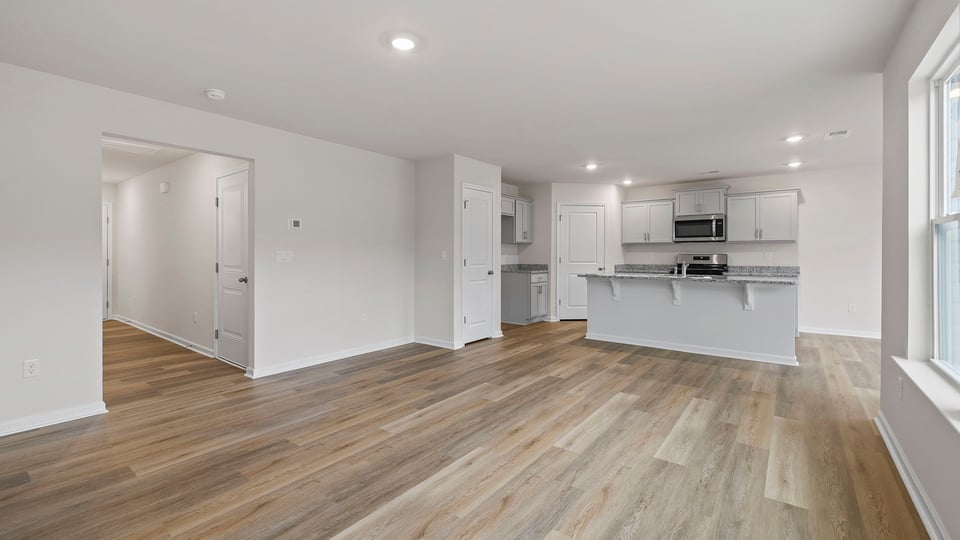 View from family room of kitchen and hallway to the entrance.