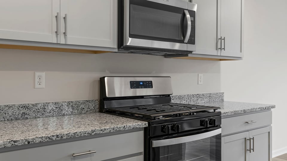 Kitchen features stainless steel appliances.