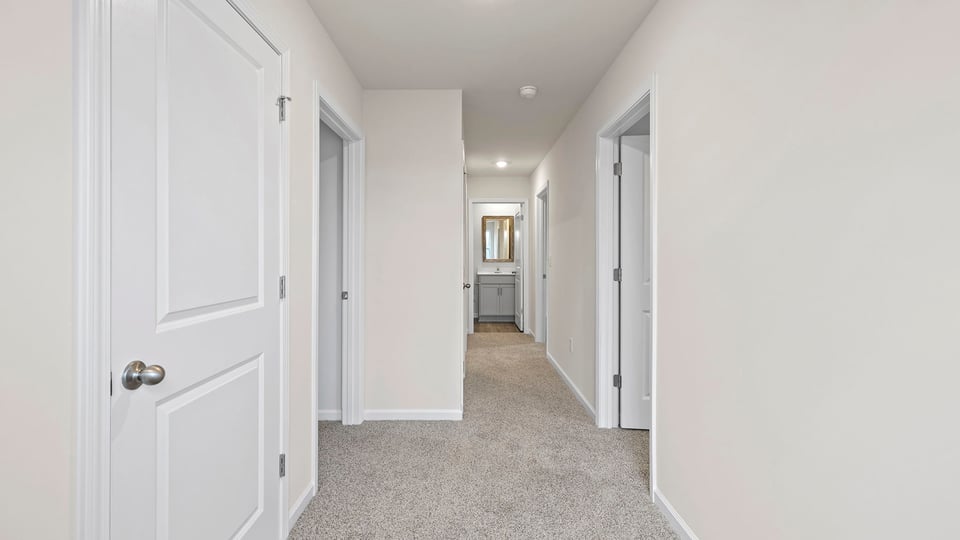 View of landing at top of the stairs and hallway to bedrooms.