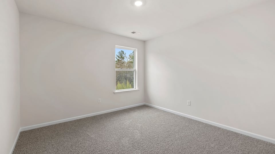 Bedroom with window and carpet.