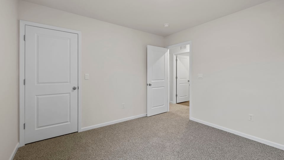 Bedroom with window and carpet.