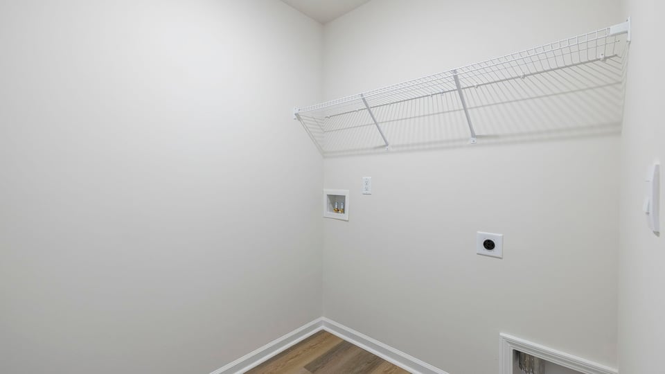 Walk-in laundry room with wire shelving.