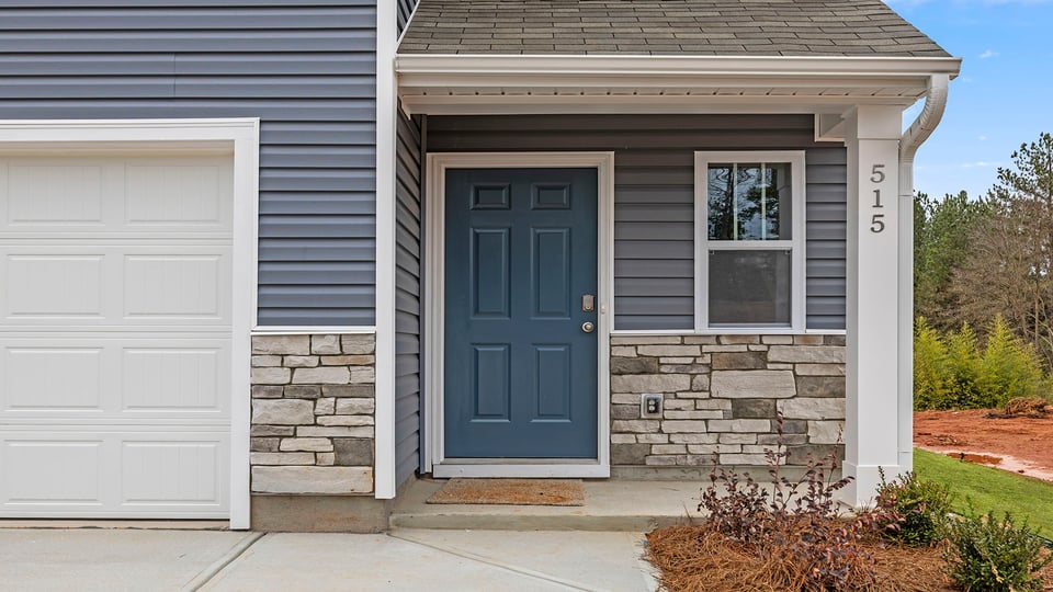 Inviting covered porch with stone entry.
