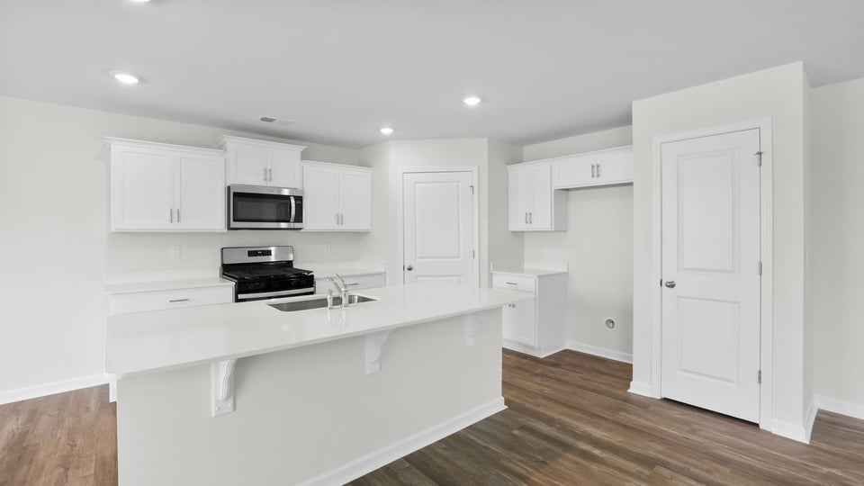 Kitchen and island with quartz countertops.