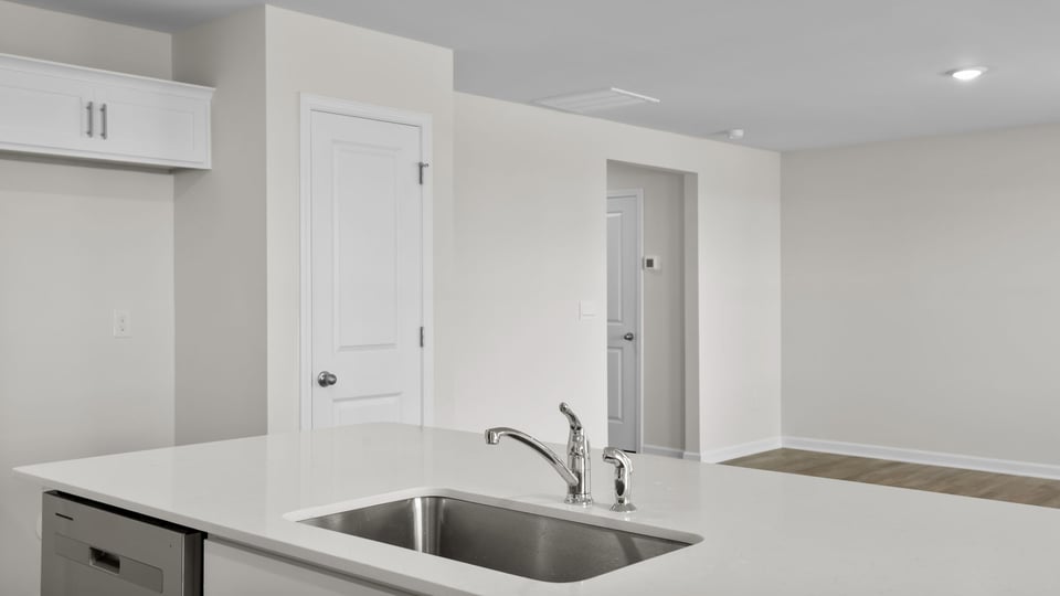 Kitchen and island with quartz countertops.