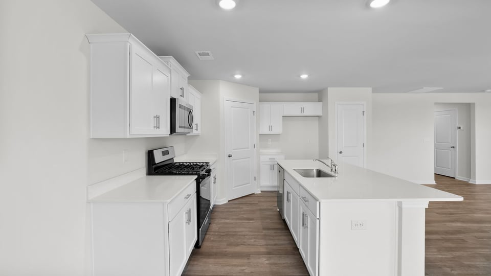 Kitchen and island with quartz countertops.