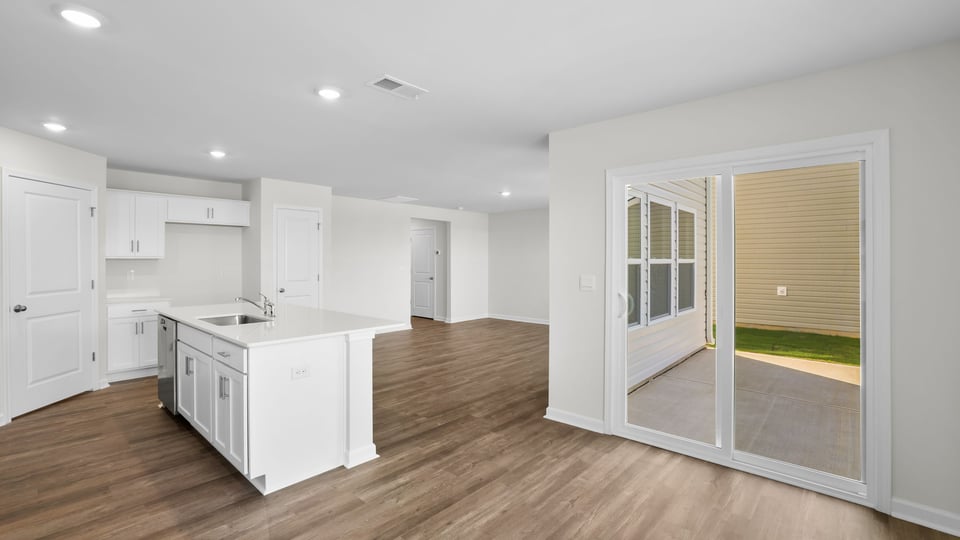 Kitchen and island with quartz countertops.