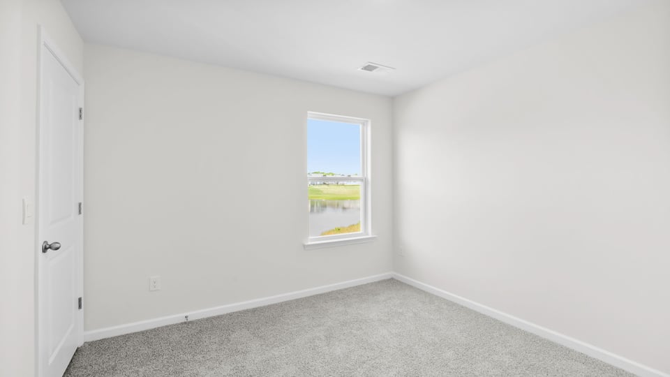 Bedroom with carpet and window.