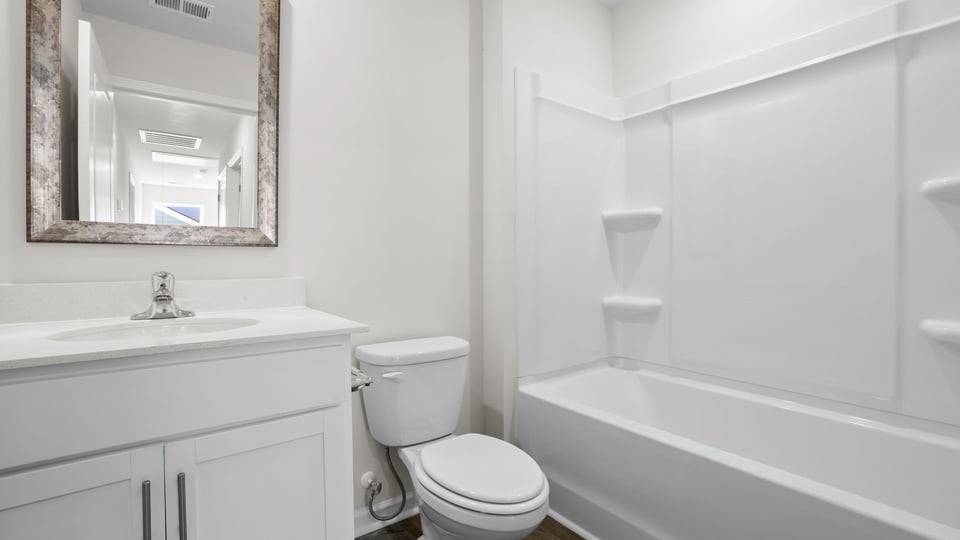 Bathroom with single vanity sink and bathtub.