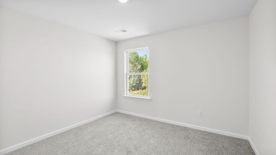 Bedroom with carpet and window.