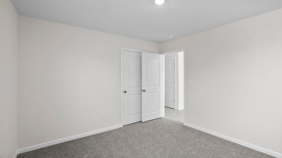 Bedroom with carpet and window.