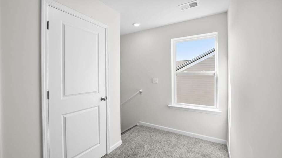 Bedroom with carpet and window.