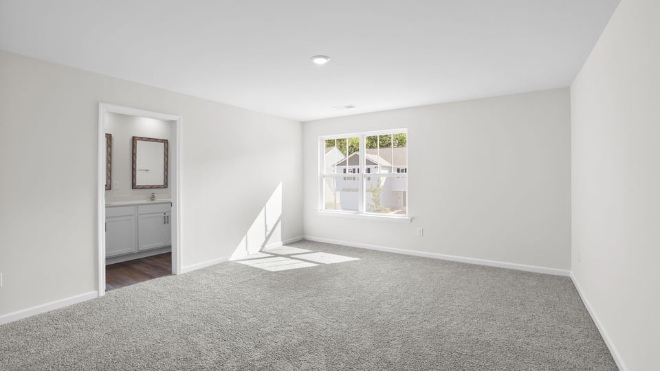 Bedroom with carpet and window.