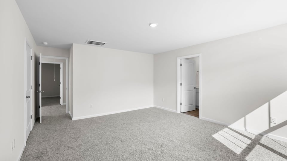 Bedroom with carpet and window.