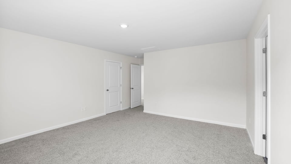 Bedroom with carpet and window.