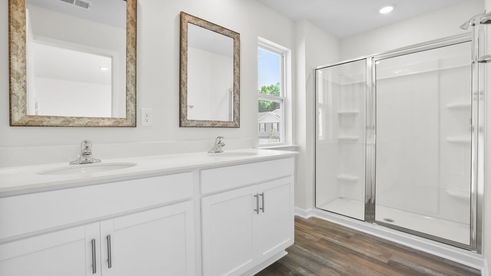 Bathroom with walk in shower and double vanity sink.
