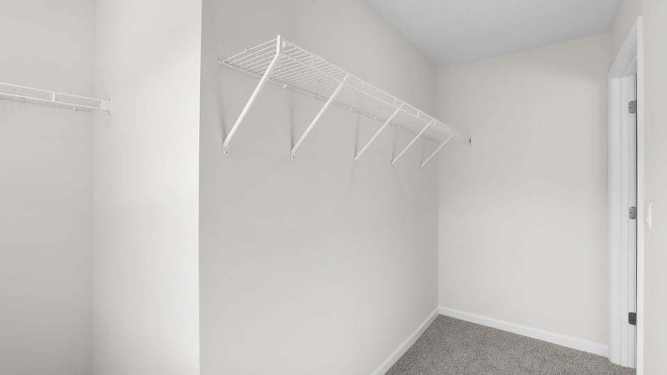 Closet with carpet.