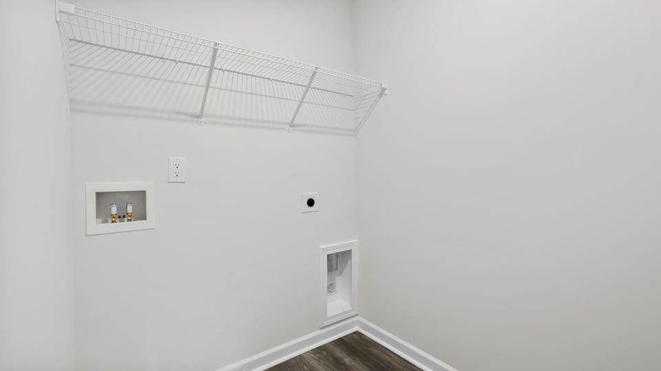Laundry room with hanging storage racks.