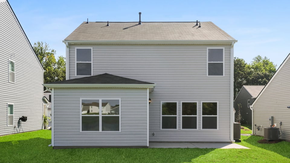 Back extrior of home with large backyard.