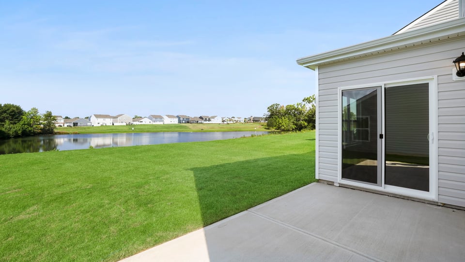 Back exterior of home with patio.
