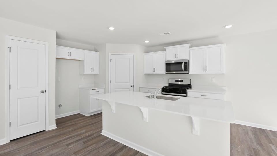 Kitchen and island with quartz countertops.a