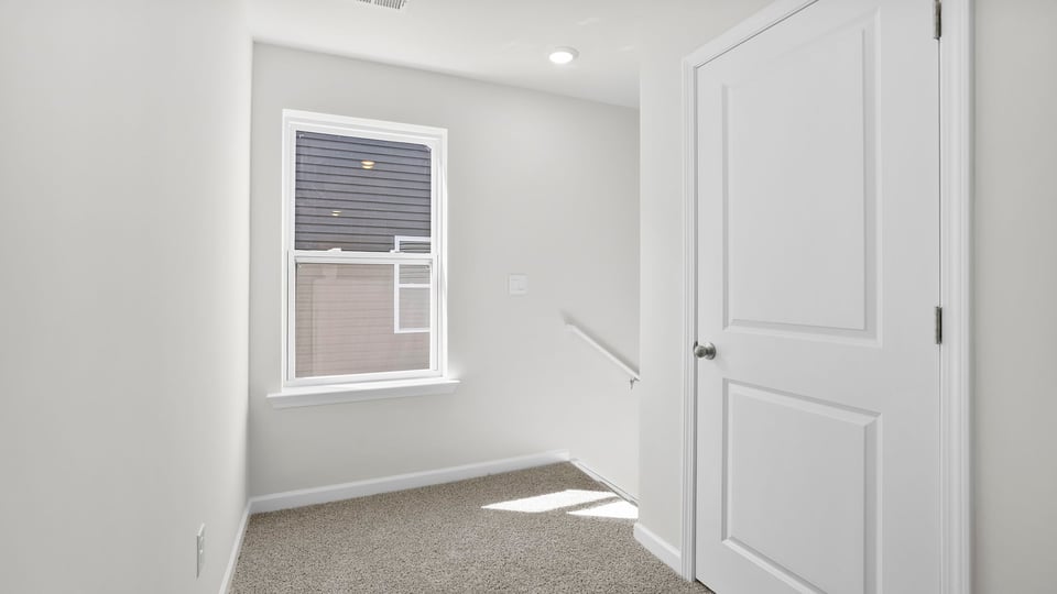 Bedroom with carpet and window.