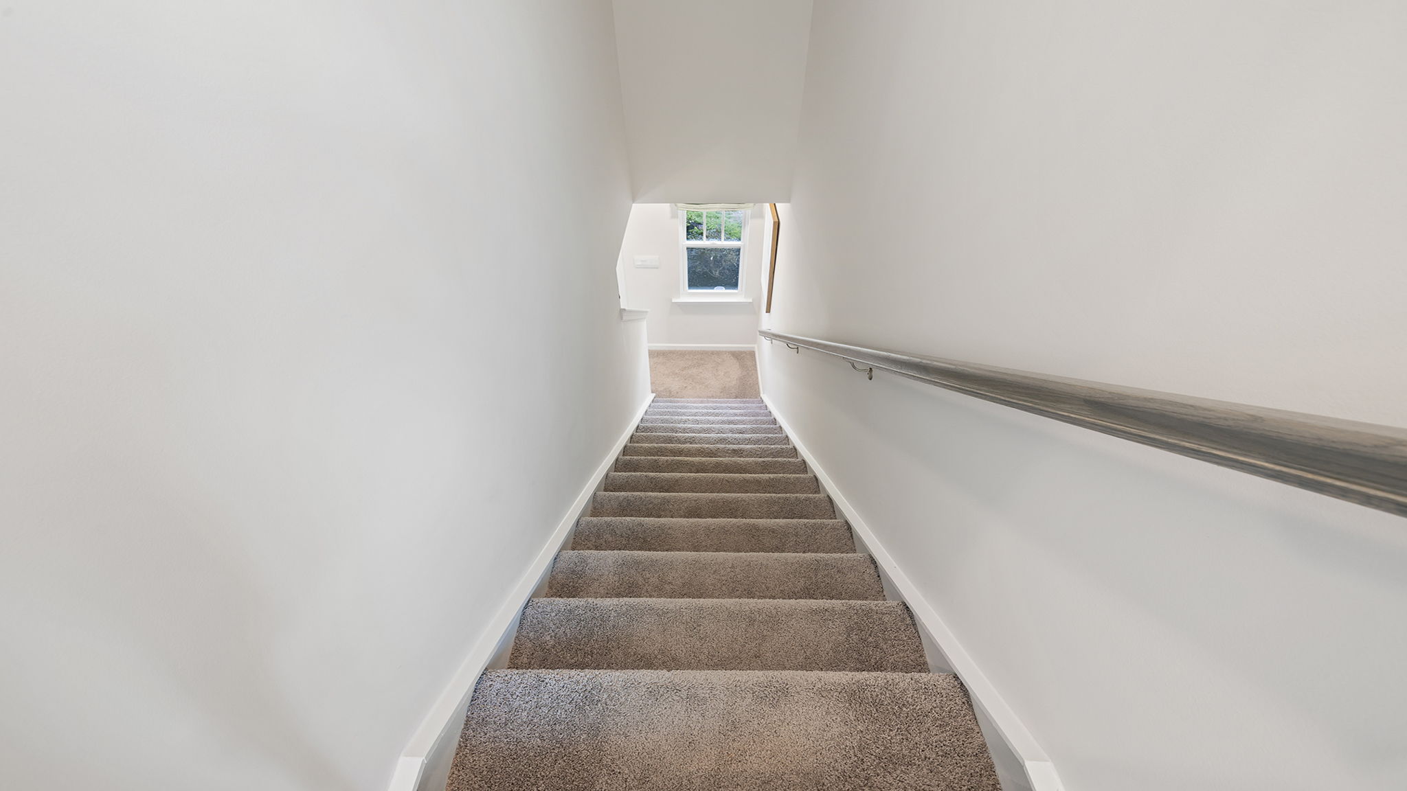 Stairs to second level with carpet.