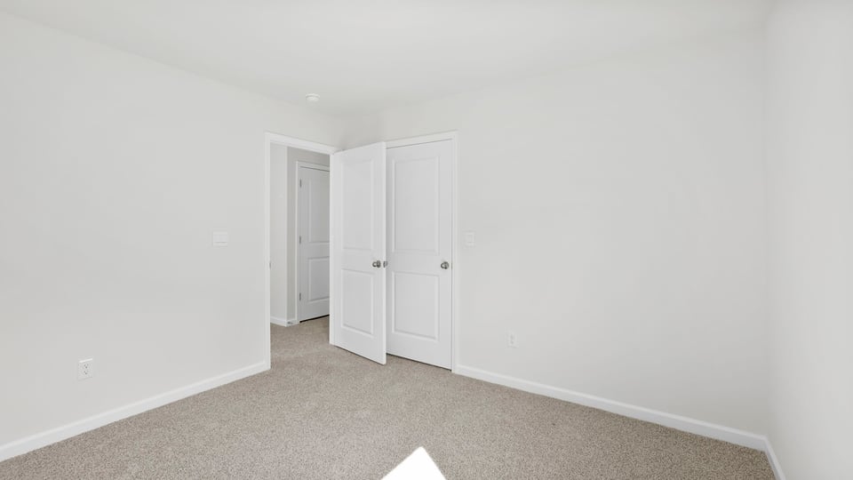 Bedroom with carpet and window.