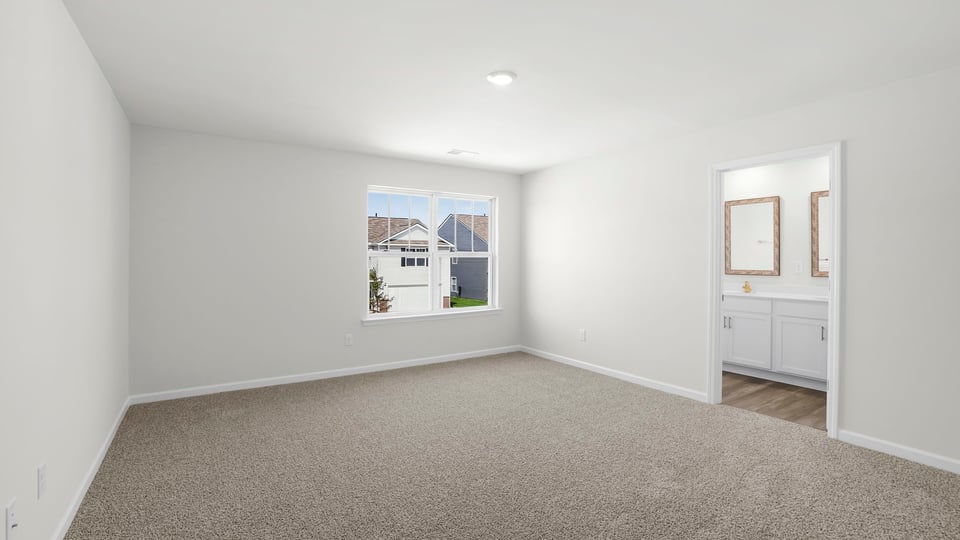 Bedroom with carpet and window.