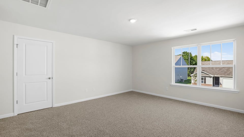 Bedroom with carpet and window.