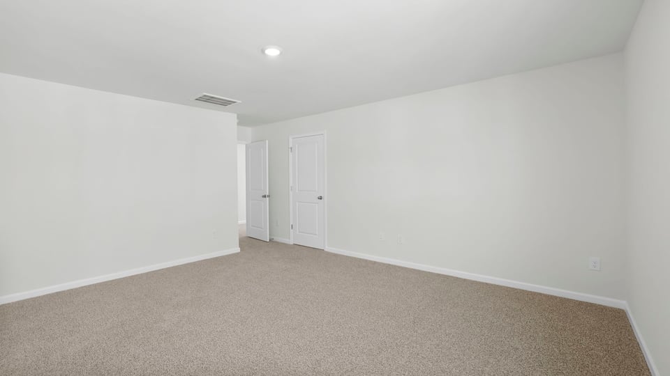 Bedroom with carpet and window.