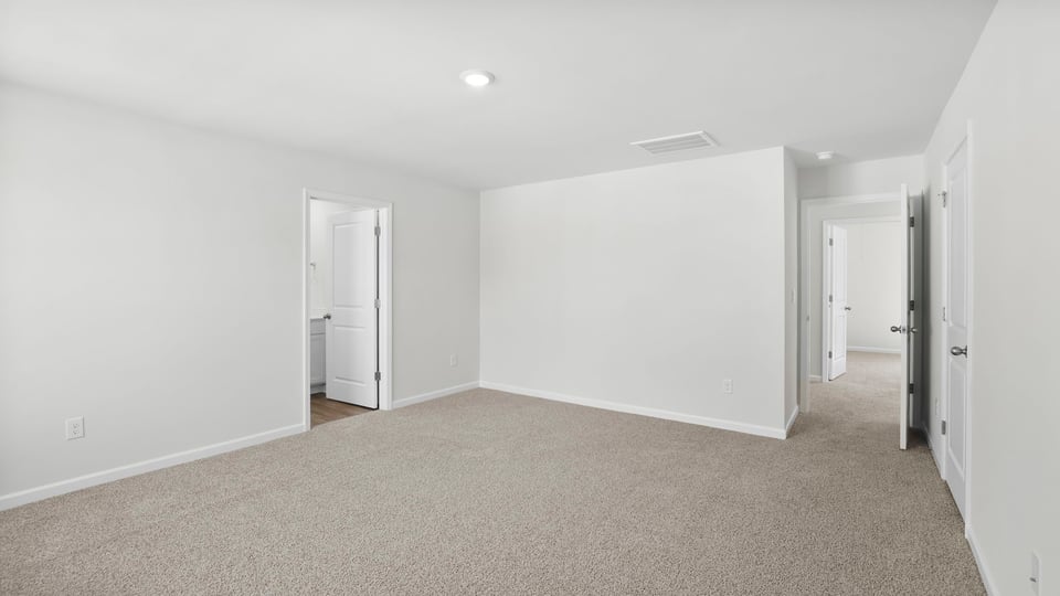 Bedroom with carpet and window.