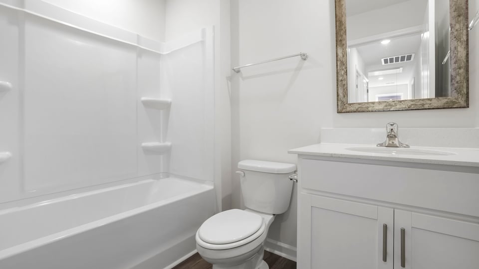 Bathroom with bathtub and single vanity sink.