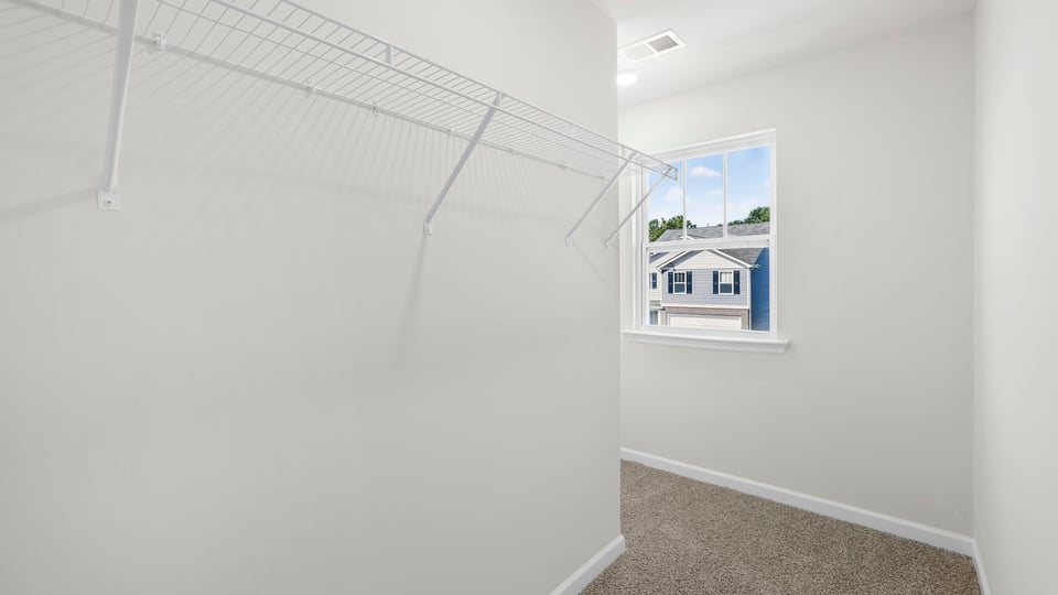 Closet with hanging storage racks.
