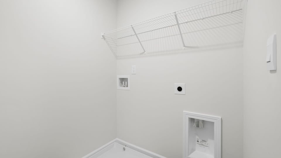 Laundry room with hanging storage racks.