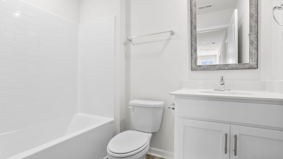 Hall bathroom with vanity and combination shower / tub.
