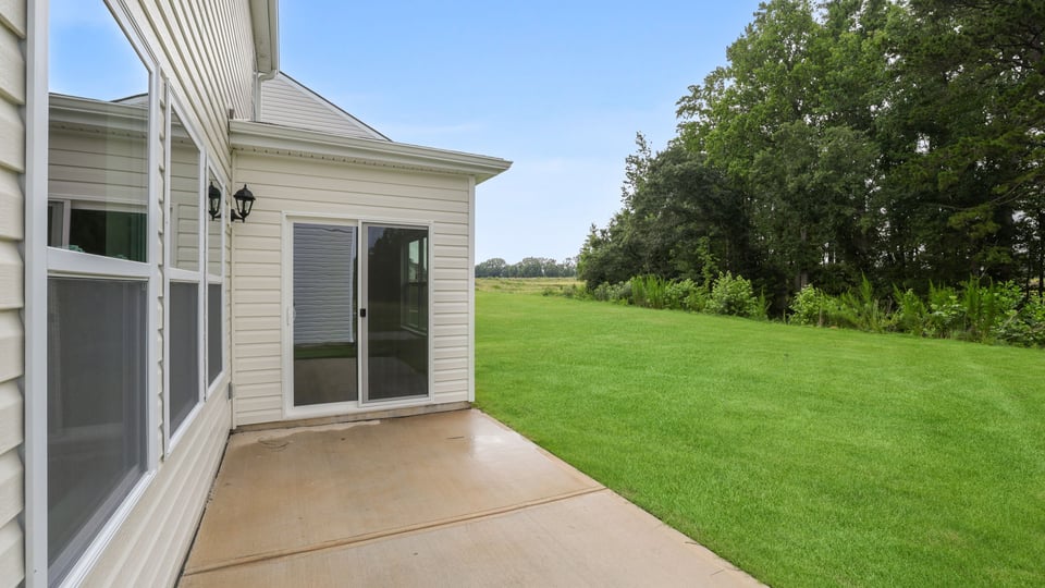 Back exterior of home with patio