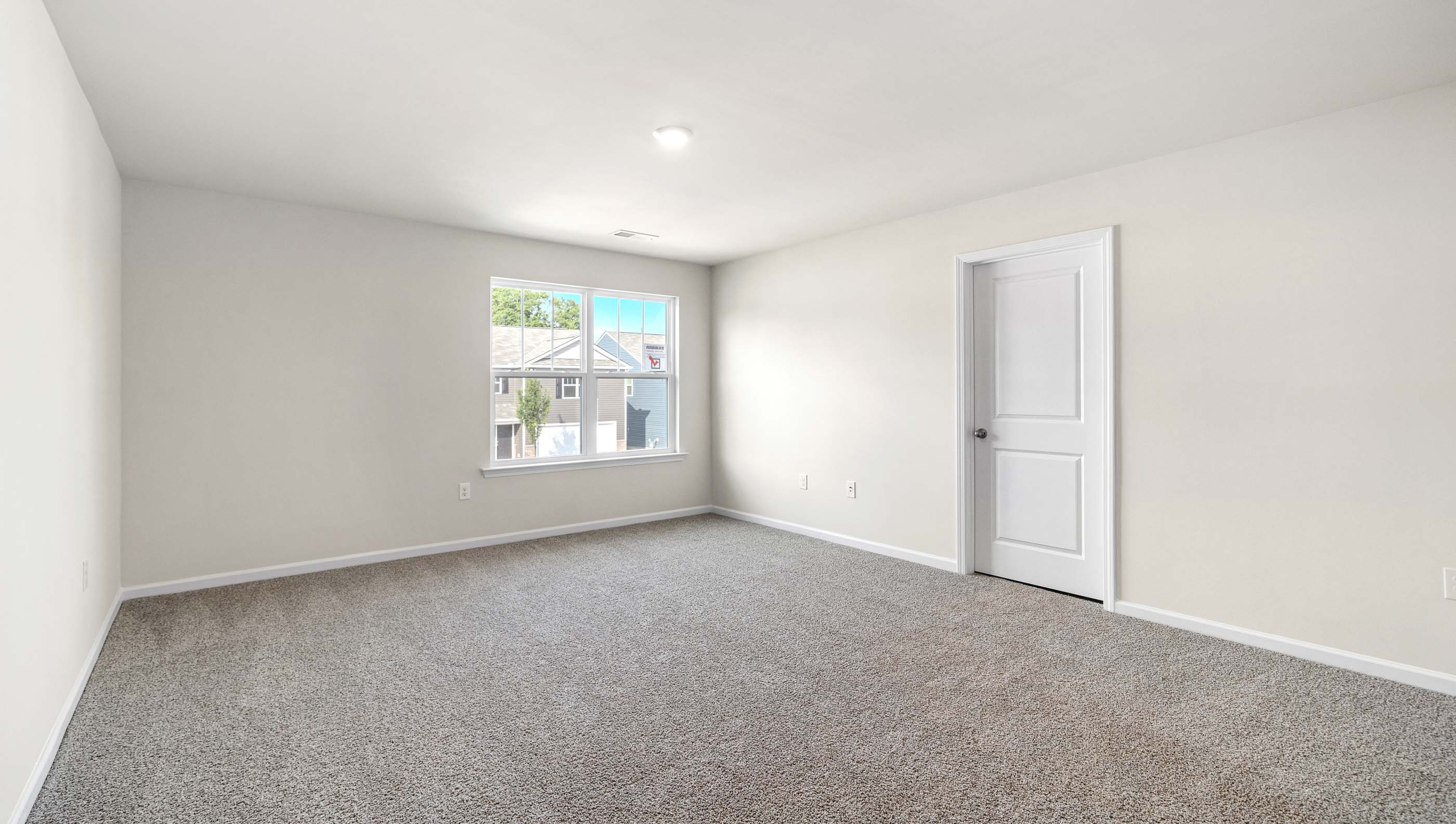 Bedroom with carpet and window.