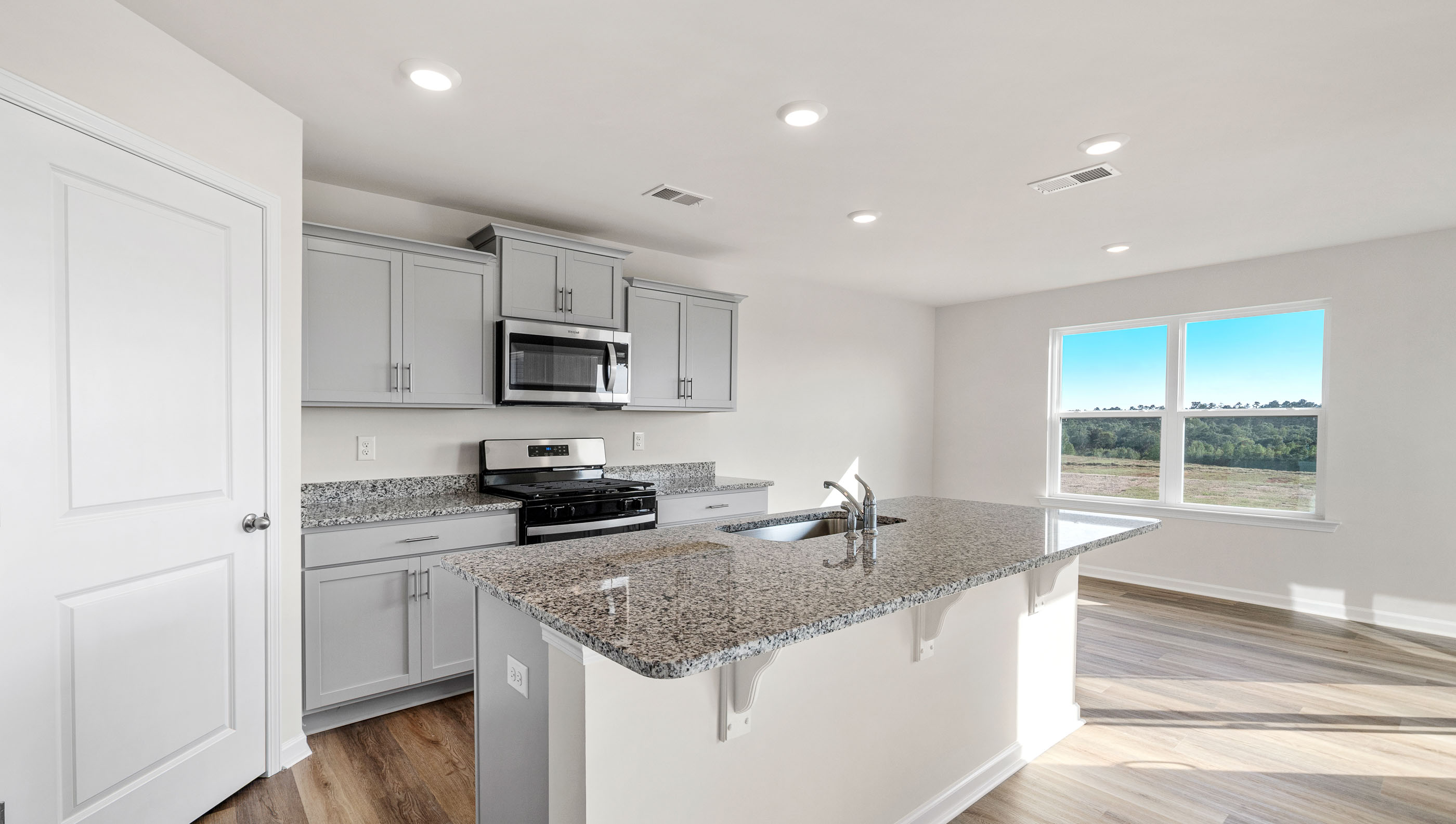 Kitchen with island and granite countertops