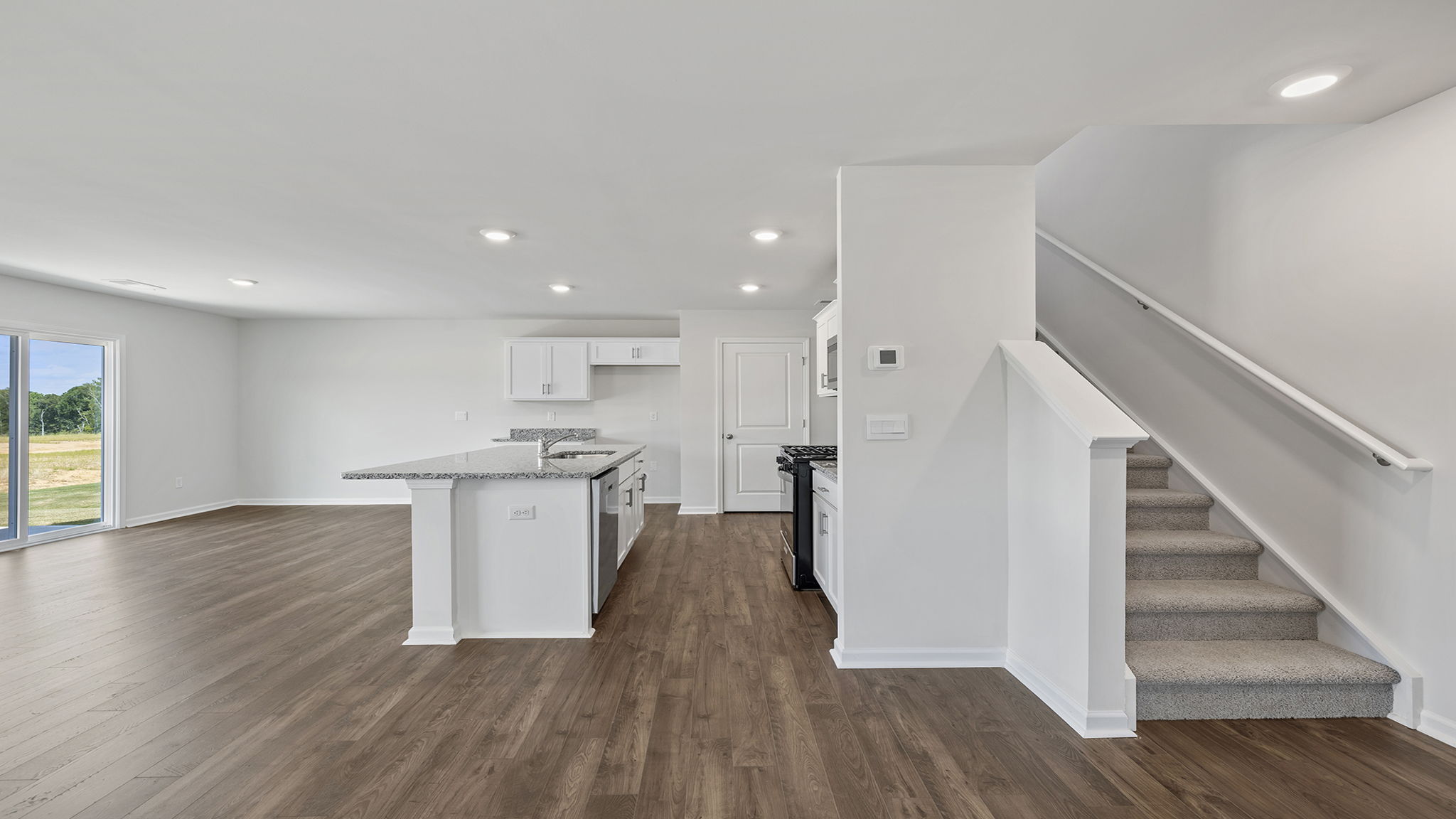 Foyer and view of open floor plan and staircase placement.