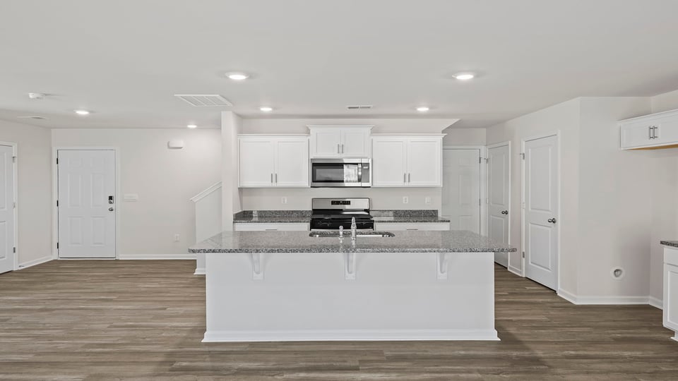 Kitchen island hosts sink and dishwasher.