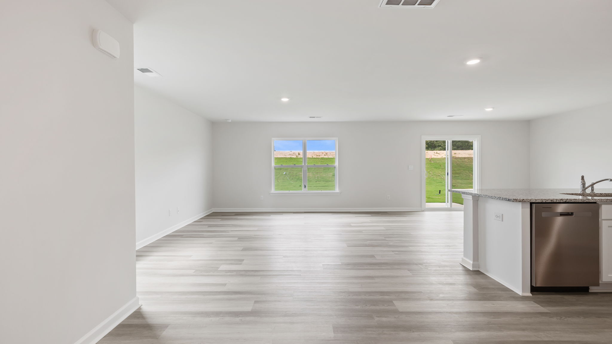View of open floor plan with combination dining and living areas.