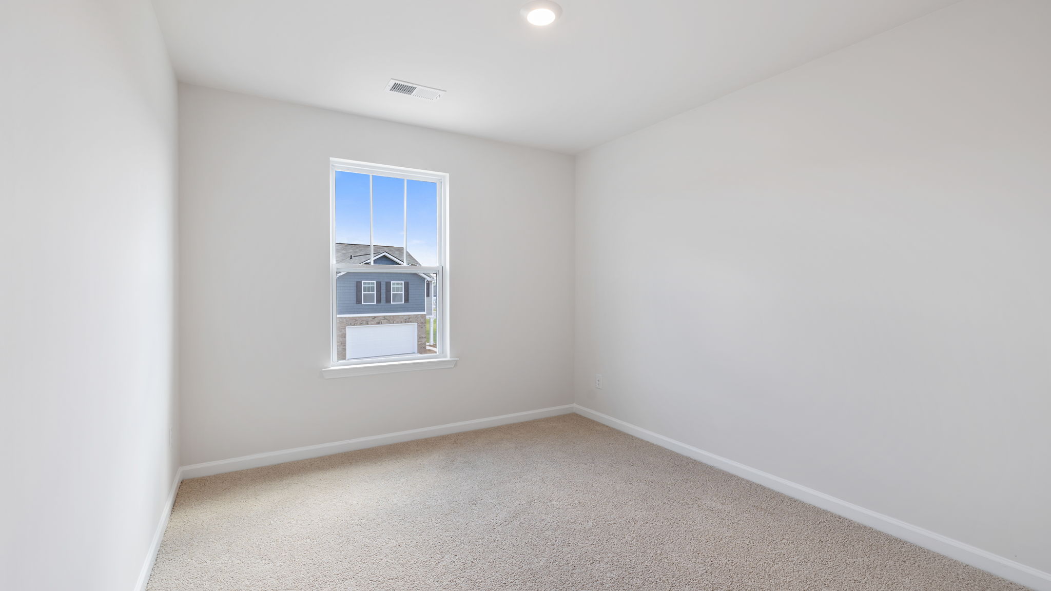 Bedroom with carpet and window.