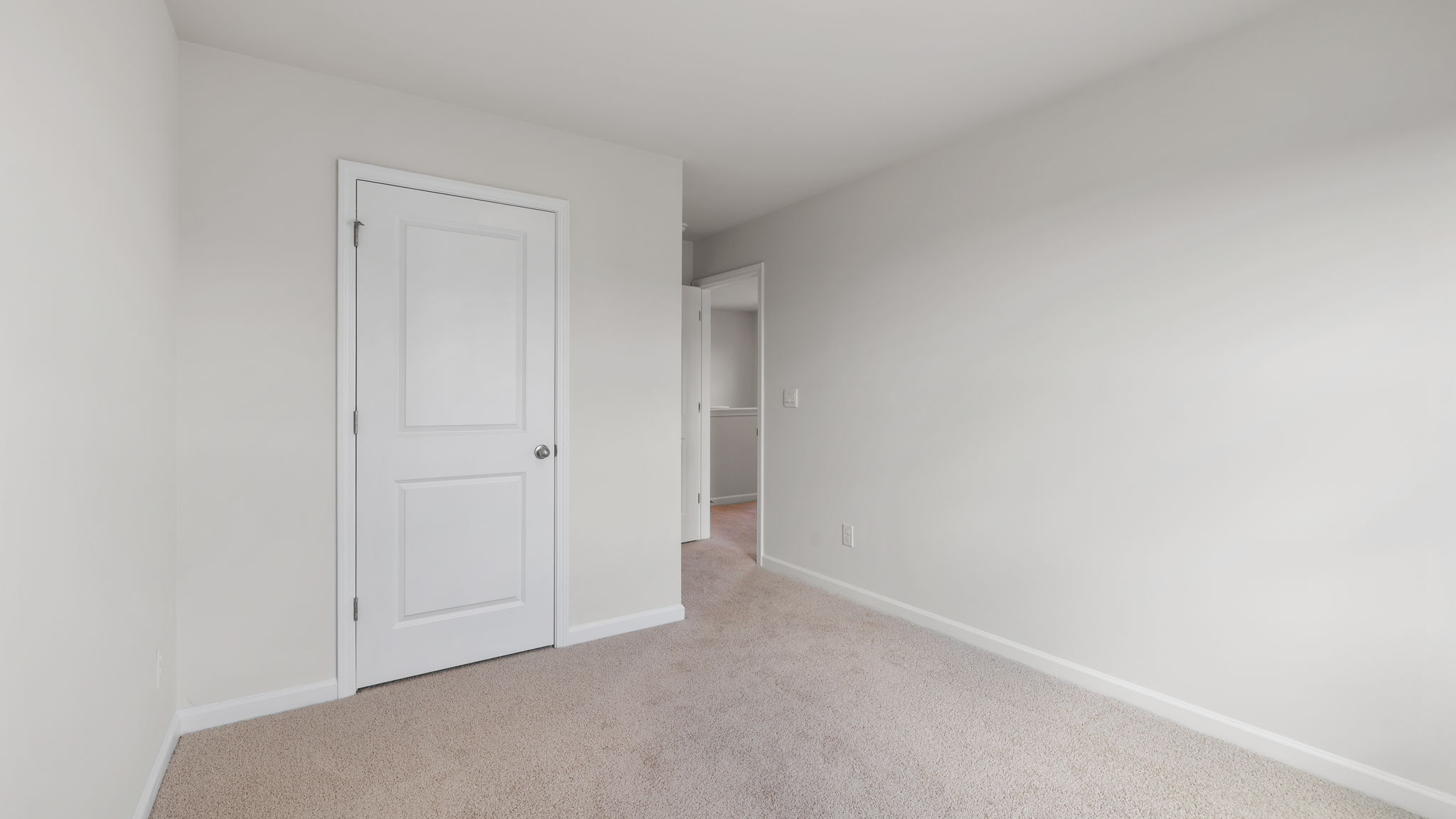 Bedroom with carpet and window.