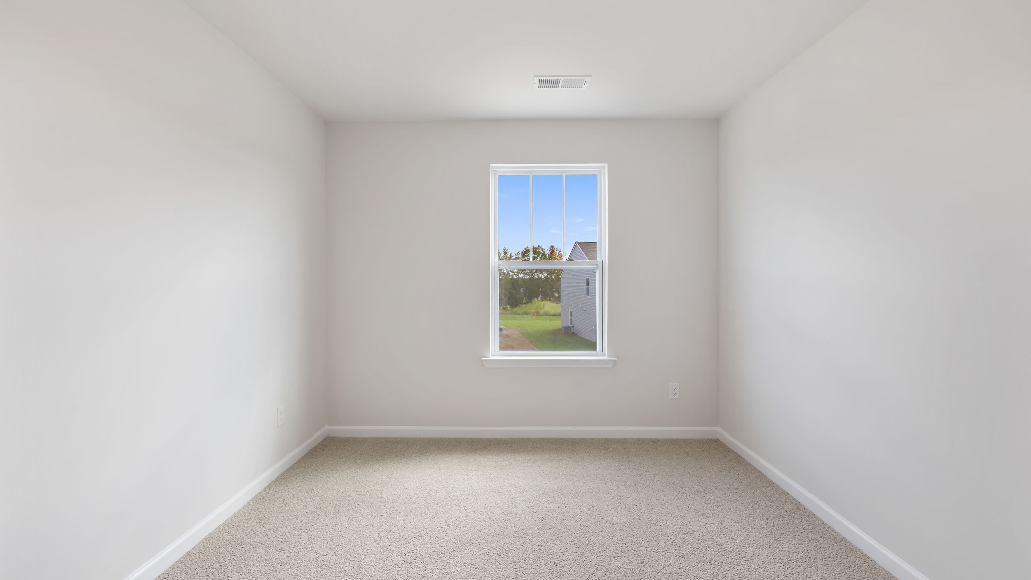 Bedroom with carpet and window.