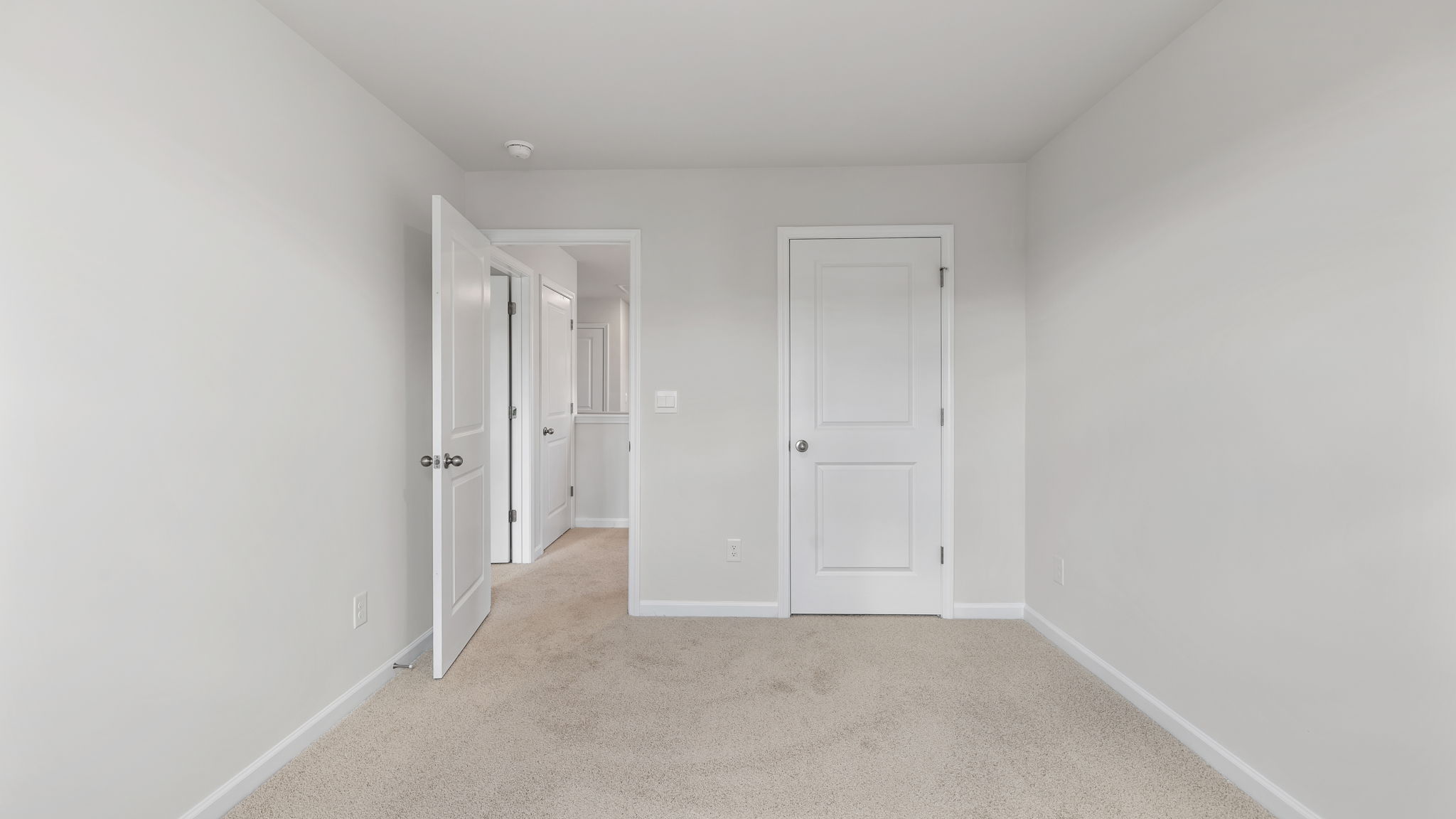Bedroom with carpet and window.